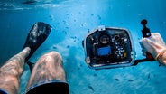 man with camera under the sea